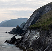 Ireland, County Kerry, Dunmore Head. Rocky cliffs rise from ocean.