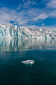 Lilliehook Glacier reflects on arctic waters. Lilliehookfjorden, Spitsbergen Island, Svalbard, Norway.