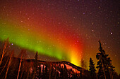 USA, Alaska, Chena Hot Springs Resort. Aurora borealis and mountain.