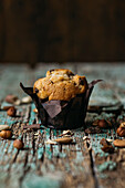Front view of a muffin with chocolate chips and nuts