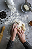 From above crop hand of unrecognizable female rolling fresh dough for pastry in cozy kitchen