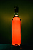 Bottle of aromatic table red wine placed in studio on dark background