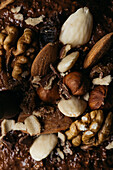 Close-up view from above of different kind of nuts with chocolate