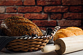 Delicious wholegrain bread in straw basket on table