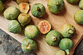 Ripe sweet green figs, freshly harvested from domestic tree on wood cutting board. Also known as ripe white figs