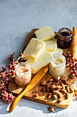 An elegant cheese board array featuring a selection of cheeses, nuts, and fruit preserves, ideal for a sophisticated gathering or wine tasting event