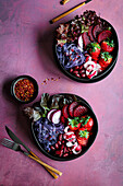 Purple and red salad bowl with strawberries