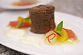 Chocolate soufflé with citrus fruits and cream