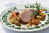 Saddle of veal with potatoes and vegetables