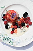Strawberries in Riesling jelly with berries and cream