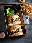 Cheeseburger with cocktail sauce and deep-fried onion rings