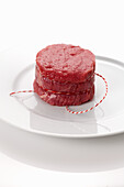Raw fillet of beef tied with kitchen twine