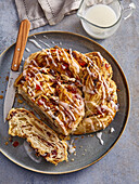 Cinnamon bun with pecan nuts and candied cherries