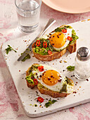 Avocado crostini with fried egg and chilli