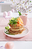 Fluffy herb pancakes with smoked salmon and salad garnish