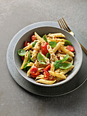 Penne with tomatoes, basil and pine nuts