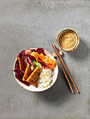 Buddha bowl with tofu, vegetables and peanut sauce