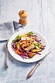 Curried chicken fillets on red cabbage salad