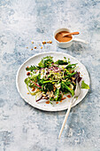 Lukewarm vegetable salad with nuts and sprouts