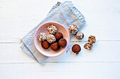 Plum energy balls with coconut flakes and cocoa powder