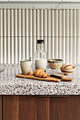 Breakfast in modern kitchen with terrazzo worktop and wooden fronts