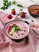 Strawberry and almond smoothie bowl with cocoa nibs