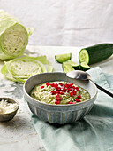 Green smoothie bowl with pomegranate seeds