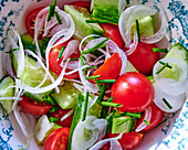 Salad with tomatoes, cucumber, onions and chives