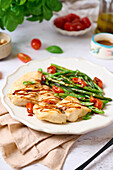 Grilled sea bass with green beans and tomatoes