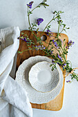 Rustic summer table setting with ceramic plates and wildflowers