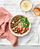 Quinoa bowl with rocket, chickpeas and tomatoes