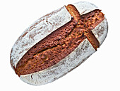 Crusty bread loaf with bread slice and knife