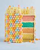Colourful layer cake with sugar pearl decoration