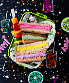 Colourful sandwiches in lunchbox with vegetable skewer