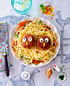 Children's spaghetti with patties and vegetable decoration