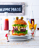 Monster hamburger with fries and ketchup