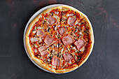 Pizza with ham and mushrooms