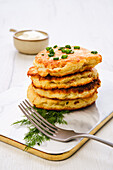 Potato pancakes with chopped salmon and sour cream