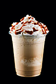 Caramel milkshake with whipped cream and caramel syrup