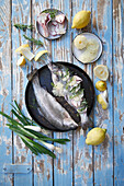 Raw trout with lemon slices and herbs