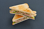 Club sandwich with ham and pickled cucumber