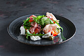 Fresh salad with jamon, mozzarella, tomatoes and olives