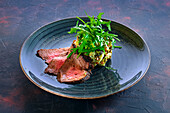 Grilled beef with potato salad and rocket salad