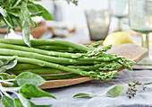 Fresh green asparagus on a wooden platter