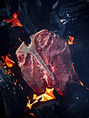 T-bone steak on hot embers