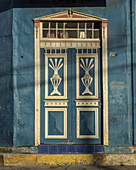 Detail of the door of a painted, metal-sheathed Victorian building in Castro on Chiloe Island, Chile.