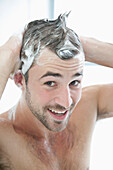 Smiling Man Washing Hair in Shower