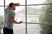 Man Looking out of Window