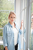 Young Woman Standing by Window