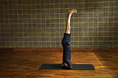 Mature Man Practicing Yoga, Headstand